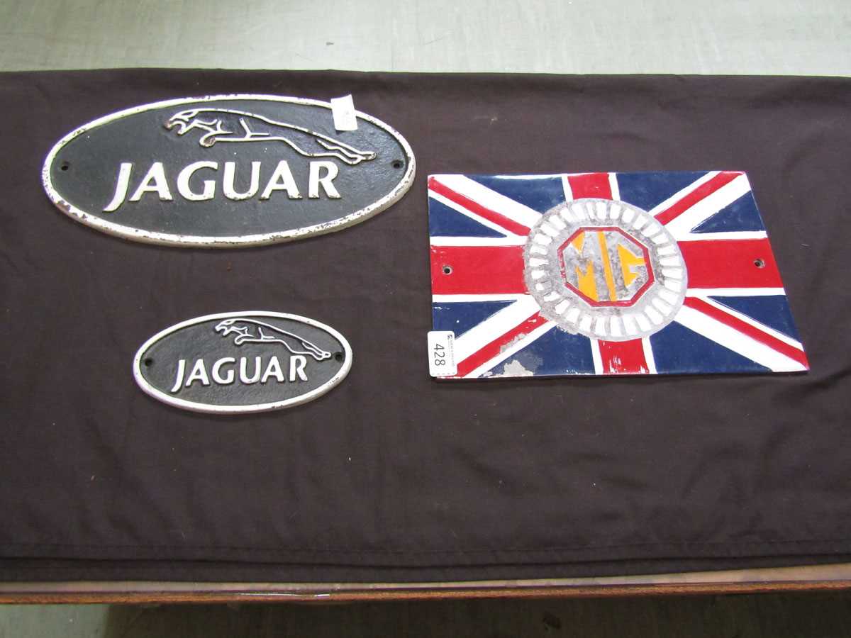 Three reproduction cast metal wall mounted signs, two being for Jaguar, the other MG