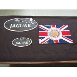 Three reproduction cast metal wall mounted signs, two being for Jaguar, the other MG