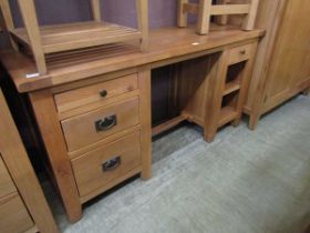 A modern oak twin pedestal dresser base having open storage being flanked by drawers and open