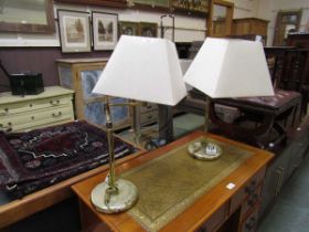 A pair of brass effect table lamps