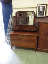 An Edwardian mahogany inlaid dressing chest having swing mirror with trinket drawers to top, the