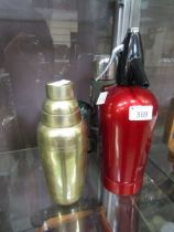 A soda syphon, cocktail shaker, two enamelled mugs and a vacuum flask