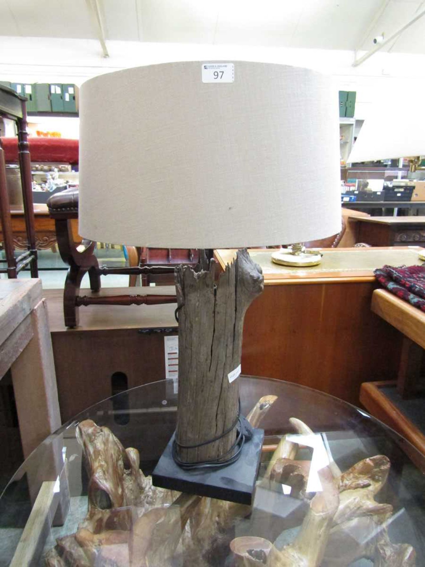 A modern driftwood table lamp with shade