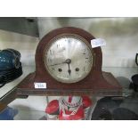 An oak cased Nelson hat style mantel clock on bracket feet