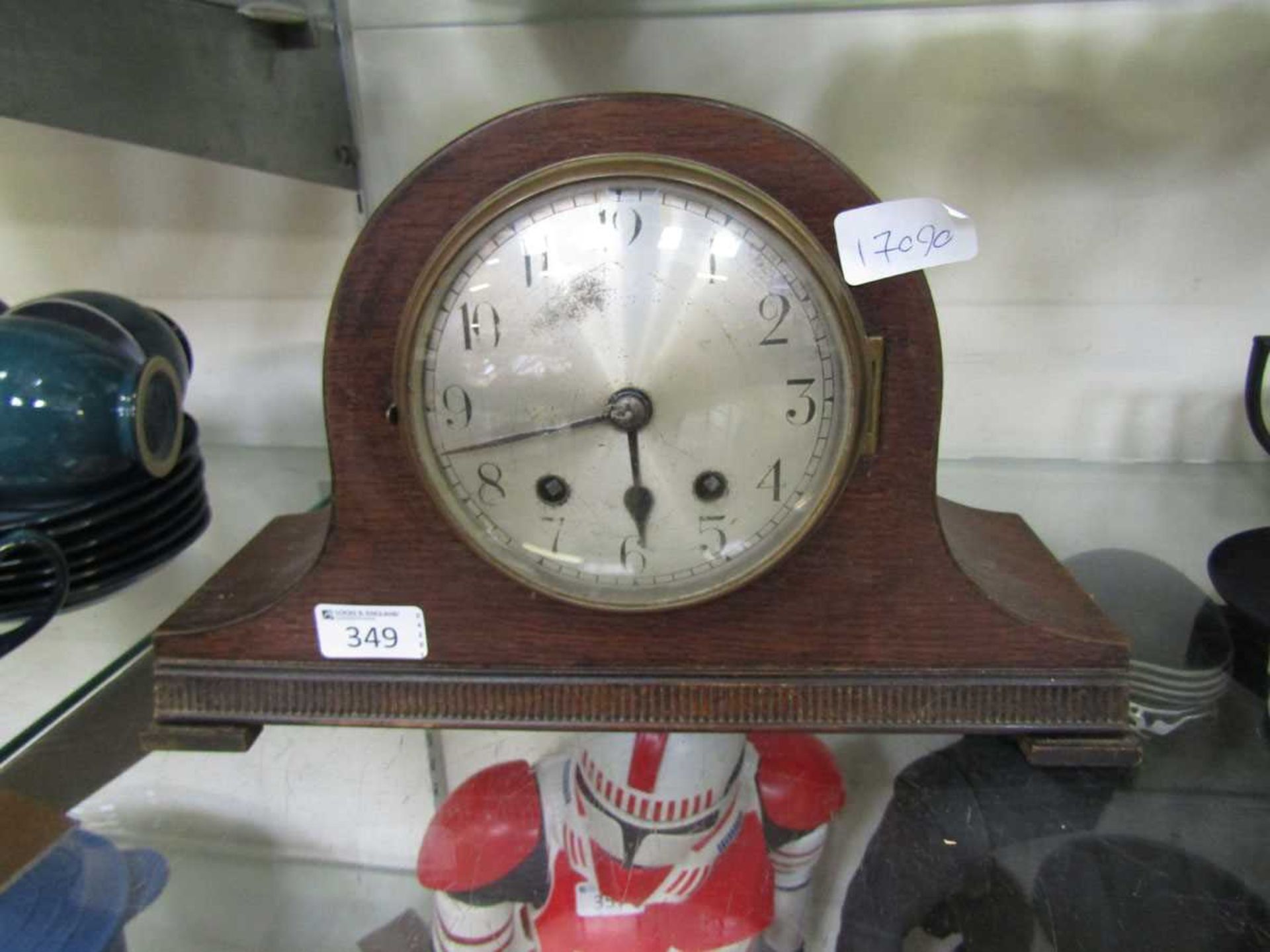 An oak cased Nelson hat style mantel clock on bracket feet