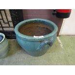 A large turquoise glazed garden pot