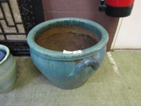 A large turquoise glazed garden pot