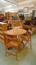 A modern beech effect drop leaf table with a set of three folding matching chairs table approx 75cm