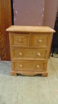 A small waxed pine chest of two short over two long drawers approx 61cm