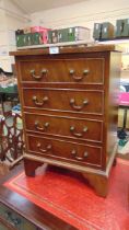 A reproduction mahogany four drawer chest of small proportions approx 65cm