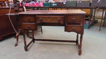 A mid-20th century possibly elm desk having a centre drawer flanked by two small drawers approx 74cm