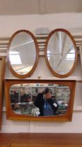 Two mid-20th century oval teak framed mirrors together with one other