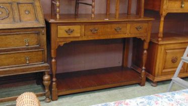 A mid-20th century oak dresser base having three drawers above open storage approx 82cm