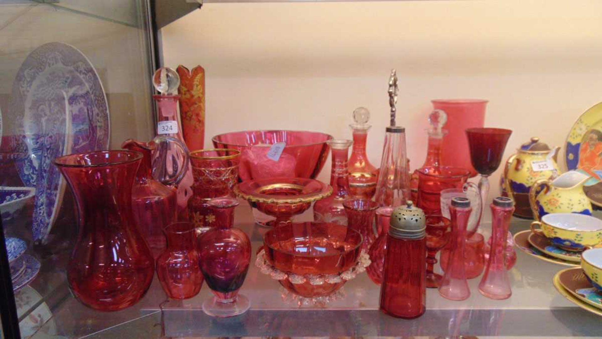 A large assortment of cranberry glassware to include vases, jugs, drinking vessels etc.