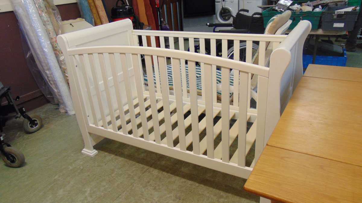 A modern cream painted child's cot approx 102cm