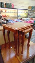 A nest of three reproduction walnut occasional tables approx 58cm