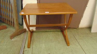 A mid-20th century teak occasional table on unusual cross membered supports by Nathan