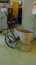 An early 20th century galvanised metal water basin on a wheeled wrought iron stand (Bottom of