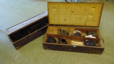 Two early 20th century wooden packing cases from Drewett's Ltd containing a selection of brown