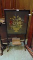 A Victorian mahogany framed screen with still life tapestry under glass