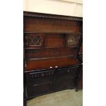 A mid-20th century dark oak dresser having raised plate rack to top, the base having two drawers