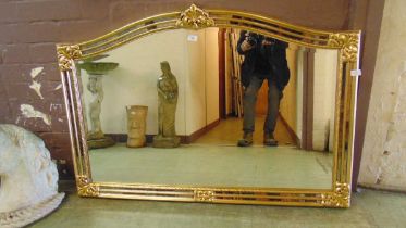 A reproduction gilt framed over mantle mirror