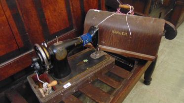 A dome cased Singer manual sewing machine