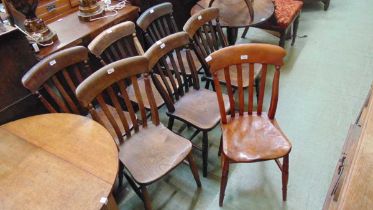 A collection of seven lathe back elm dining chairs