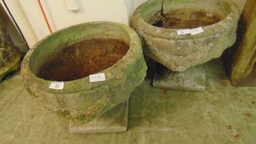 A pair of weathered garden urns