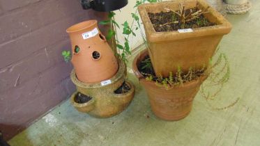 A selection of garden pots to include a strawberry planter