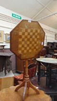 A late 19th century oak tilt top games table