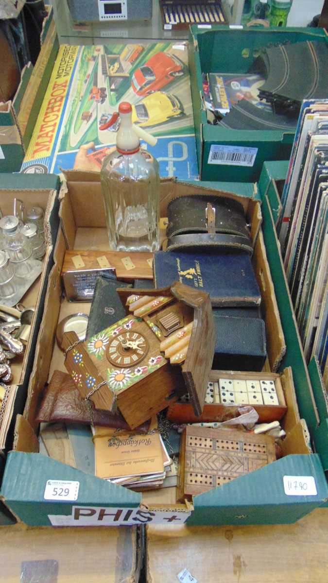 A tray containing an assortment of items to include soda siphon, dominos, plaque, reproduction