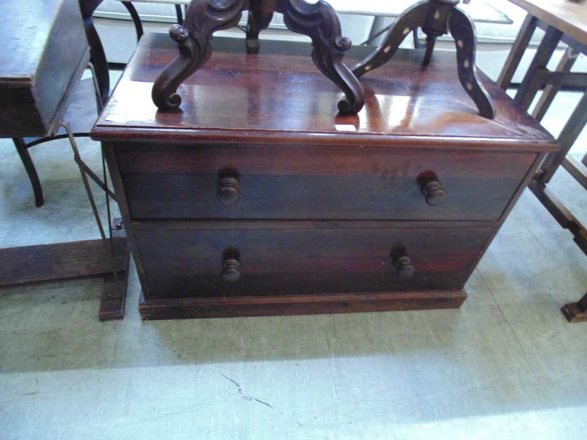 A stained pine chest of two long drawers