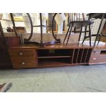 A mid-20th century stained oak effect cabinet having two drawers, open storage, and record storage