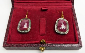 A PAIR OF RUBY AND DIAMOND DROP EARRINGS, the large central stones with an approximate weight of 4.