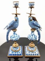 CANDELABRA, 48cm high, a pair, in the form of parrots, blue and white glazed ceramic, gilt