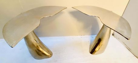 SIDE TABLES, a pair, 55cm high, 54cm wide, 44cm deep, in the form of whale tails polished metal. (2)