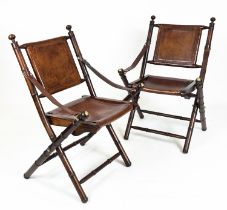 CAMPAIGN CHAIRS, a pair, stitched tan leather, folding faux bamboo frames, 86cm H x 56cm. (2)