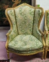 LOUIS XVI STYLE BERGERE A OREILLE, 19th century gesso applied giltwood frame, green silk floral