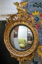 CONVEX MIRROR, 112cm H, Regency giltwood and gesso with foliate and eagle crest.