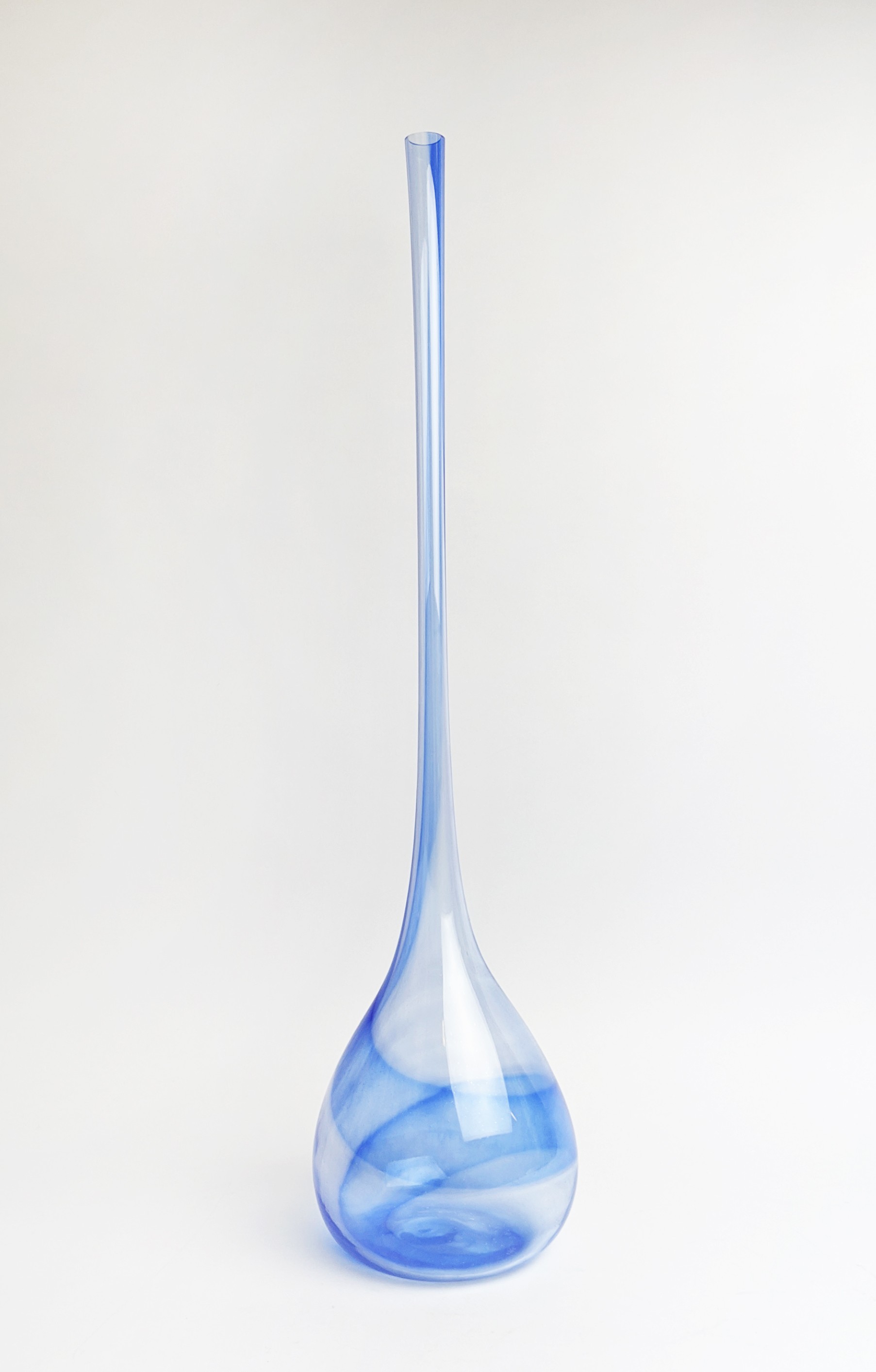 A MURANO TALL BLUE GLASS VASE, of baluster form with an elongated neck, with varying shades of