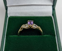 A 9CT YELLOW GOLD AMETHYST AND DIAMOND DRESS RING, the pear cut amethyst stone of 0.45 carats,