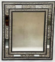 DUTCH WALL MIRROR, 19th century carved ebony and repoussé silver metal mounted, bevelled mirror with