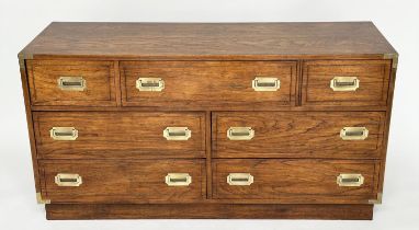 LOW CHEST, campaign style elm and brass bound with seven drawers, 143cm x 46cm x 73cm H.