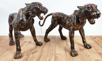 SCULPTURAL TIGERS, a pair, cast metal. 62cm high, 120cm wide, 40cm deep (2)