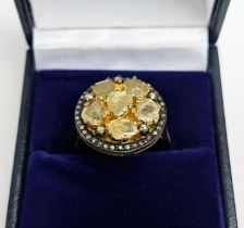 AN UNUSUAL MIXED CUT DIAMOND CLUSTER RING, with rose cut diamond centre surrounded by five further