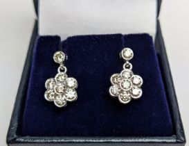 A PAIR OF 18CT WHITE GOLD AND DIAMOND CLUSTER DROPLET EARRINGS, of flower-head design, the