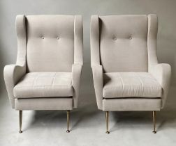 WING ARMCHAIRS, a pair, 1960's style with parchment cotton upholstery and splay gilt metal supports,