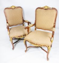 OPEN ARMCHAIRS, a pair, each 68cm x 115cm H, with carved showframes and gilt detail. (2)