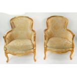 BERGERES, a pair, each 68cm x 93cm H with gilt showframes and gold patterned upholstery. (2)